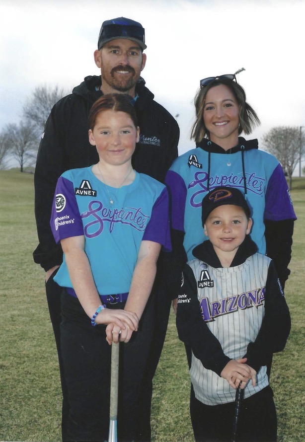 The Barnes family — Kelly, Chris, and their kids on the field